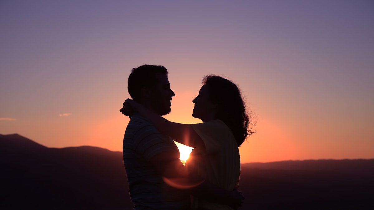 silhouette of hugging couple